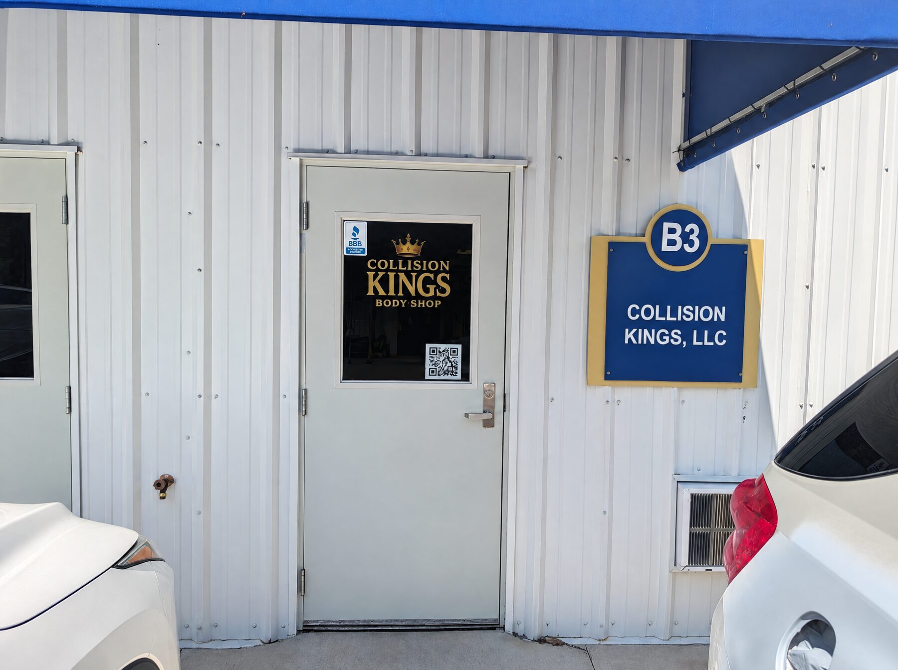 The Collision Kings front door at Unit B3 under the blue awning